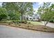 Attractive home with a combination of brick and white siding, highlighted by well-manicured landscaping and an inviting entrance at 4812 Cornoustie Ct, Holly Springs, NC 27540