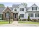 Charming two-story home featuring a mix of white siding and brick, with dark shutters and manicured landscaping at 4812 Cornoustie Ct, Holly Springs, NC 27540