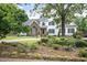 Charming two-story home featuring a blend of brick and white siding, complemented by a beautifully landscaped front yard at 4812 Cornoustie Ct, Holly Springs, NC 27540