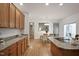 Bright kitchen featuring wood floors, granite countertops, and a view into the adjacent dining area at 4812 Cornoustie Ct, Holly Springs, NC 27540