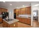 Well-lit kitchen showcasing granite countertops, a central island with a cooktop, and ample cabinet space at 4812 Cornoustie Ct, Holly Springs, NC 27540