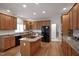 Spacious kitchen features a granite island, stainless appliances, and plenty of wood cabinets at 4812 Cornoustie Ct, Holly Springs, NC 27540