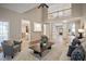 Bright, open-concept living room featuring hardwood floors, a vaulted ceiling, and views into other areas of the home at 4812 Cornoustie Ct, Holly Springs, NC 27540