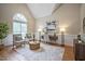 Bright living room boasts a vaulted ceiling, large window, and hardwood flooring at 4812 Cornoustie Ct, Holly Springs, NC 27540