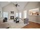 Comfortable living room with a fireplace, vaulted ceiling, hardwood floors, and an open layout perfect for relaxation at 4812 Cornoustie Ct, Holly Springs, NC 27540