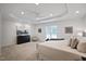 Spacious main bedroom features trey ceilings, plush carpet, and a ceiling fan at 4812 Cornoustie Ct, Holly Springs, NC 27540
