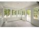 Bright sunroom with wood flooring and multiple windows offering scenic views at 4812 Cornoustie Ct, Holly Springs, NC 27540