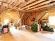 Spacious unfinished attic with exposed wood beams and plywood flooring at 497 Rockport Dr, Clayton, NC 27527