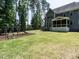 Expansive backyard with playground, seating, and plenty of green space, with home view at 497 Rockport Dr, Clayton, NC 27527
