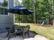 Charming backyard patio with a table, seating and umbrella, perfect for outdoor dining and relaxation at 497 Rockport Dr, Clayton, NC 27527