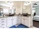 Bathroom showing granite countertops, dual copper sinks, and vanity cabinet storage at 497 Rockport Dr, Clayton, NC 27527
