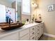 A bathroom has double sinks, a mirror, and white storage cabinets at 497 Rockport Dr, Clayton, NC 27527