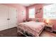 A pink bedroom has two windows, hardwood floors, and closet space at 497 Rockport Dr, Clayton, NC 27527