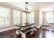 Bright dining room features a farmhouse table and benches in front of three large windows with shutters at 497 Rockport Dr, Clayton, NC 27527