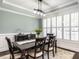 Elegant dining room with large windows, plantation shutters, and stylish light fixture at 497 Rockport Dr, Clayton, NC 27527