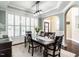 Elegant dining room with large windows, plantation shutters, and stylish light fixture at 497 Rockport Dr, Clayton, NC 27527
