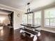 Dining room features a farmhouse table and benches and is adjacent to the living room at 497 Rockport Dr, Clayton, NC 27527