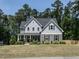 Charming two-story home with stone accents, manicured lawn, and lush landscaping at 497 Rockport Dr, Clayton, NC 27527
