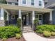 Inviting front porch with stone pillars and manicured landscaping, creating curb appeal at 497 Rockport Dr, Clayton, NC 27527