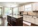 Kitchen boasts an island with granite countertops, stainless steel appliances, and ample counter space at 497 Rockport Dr, Clayton, NC 27527