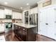 Kitchen boasts an island with granite countertops, stainless steel appliances, and ample cabinet space at 497 Rockport Dr, Clayton, NC 27527