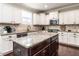 Gourmet kitchen with granite counters, island, stainless appliances and custom cabinets at 497 Rockport Dr, Clayton, NC 27527
