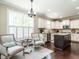 Kitchen boasts an island with granite countertops, stainless steel appliances, and a cozy seating area at 497 Rockport Dr, Clayton, NC 27527