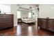 A well-decorated bedroom with hardwood floors, crown molding, and two matching dressers at 497 Rockport Dr, Clayton, NC 27527