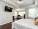 A spacious bedroom offers an attached office area, a ceiling fan, and hardwood floors at 497 Rockport Dr, Clayton, NC 27527