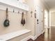 Mudroom area with coat hooks, bench, and cubbies for storage, conveniently located near the entrance at 497 Rockport Dr, Clayton, NC 27527