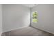 Neutral carpeted bedroom featuring a window with an outdoor view at 505 Benton Dr, Oxford, NC 27565