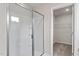 Bright bathroom features a glass shower and walk in closet with shelving for optimal storage at 507 Benton Dr, Oxford, NC 27565