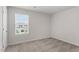 Carpeted bedroom filled with natural light from a window with a view of the neighborhood at 507 Benton Dr, Oxford, NC 27565