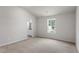 Spacious bedroom with plush carpeting, ample natural light, and a view of the outdoors at 507 Benton Dr, Oxford, NC 27565