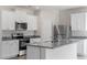 Kitchen featuring white cabinets, stainless steel appliances, and a stylish gray countertop at 507 Benton Dr, Oxford, NC 27565