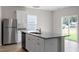 Kitchen island with gray countertop, stainless steel appliances, and ample cabinet space at 507 Benton Dr, Oxford, NC 27565
