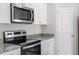 Close up of oven and microwave with gray countertops and white cabinets at 507 Benton Dr, Oxford, NC 27565