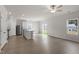Open-plan living space featuring hardwood floors, stainless steel appliances and sliding glass door at 507 Benton Dr, Oxford, NC 27565
