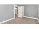 Bedroom with neutral carpet, gray walls, and trim, features a doorway to other rooms at 518 Avon Ave, Burlington, NC 27215