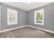 Bedroom with neutral carpet, gray walls, and double-hung windows at 518 Avon Ave, Burlington, NC 27215