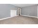 A bright bedroom with gray walls, white trim, gray carpet, and decorative mantel at 518 Avon Ave, Burlington, NC 27215