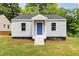 Charming single-story home featuring gray siding, a blue front door and a well-maintained lawn at 518 Avon Ave, Burlington, NC 27215