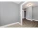 Hallway featuring gray walls, white trim, and light-colored vinyl flooring at 518 Avon Ave, Burlington, NC 27215