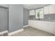 Bright kitchen featuring white cabinets, gray countertops, and gray vinyl flooring at 518 Avon Ave, Burlington, NC 27215