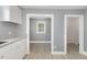 Bright kitchen featuring white cabinets, gray countertops, and gray vinyl flooring at 518 Avon Ave, Burlington, NC 27215