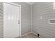 Mudroom with grey vinyl siding, grey flooring and white trim at 518 Avon Ave, Burlington, NC 27215