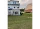Landscaped backyard featuring a well-maintained lawn and a brick patio perfect for outdoor entertaining at 523 Berry Chase Way, Cary, NC 27519