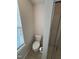 A half-bathroom featuring a sleek glass shower door and toilet at 523 Berry Chase Way, Cary, NC 27519