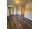 Bright bedroom featuring modern flooring, closet space, and a view into an attached bathroom at 523 Berry Chase Way, Cary, NC 27519