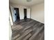 A bright bedroom showcasing modern flooring and two doorways at 523 Berry Chase Way, Cary, NC 27519